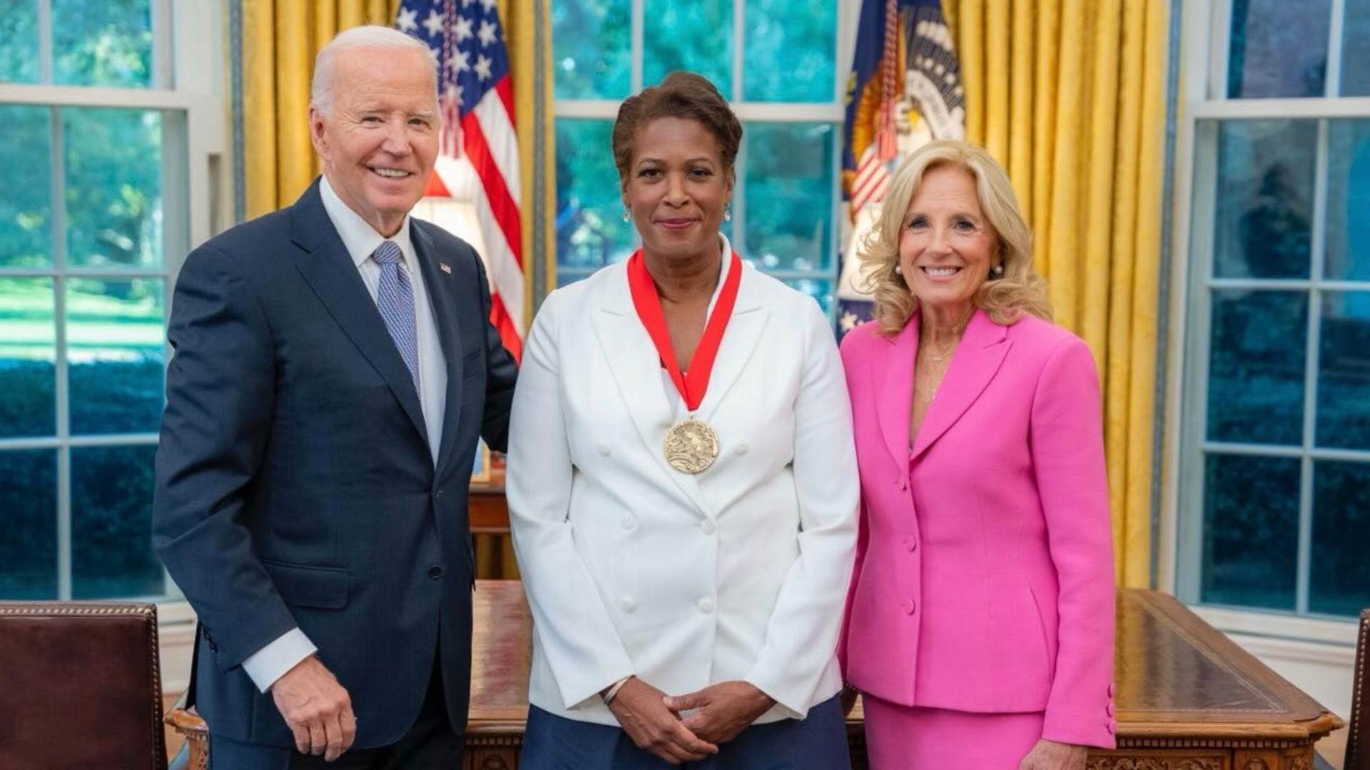 Dawn Porter in the Oval office, wearing the National Humanities medal. President Biden is on the left and Dr. Biden is on the right.