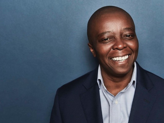 Filmmaker Yance Ford smiles directly into camera